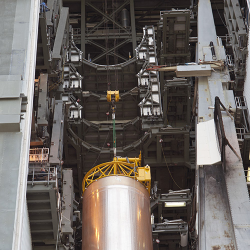A rocket fuel tank is lifted into position in the vehicle assembly building at NASA